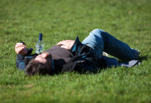drunk man lying in field