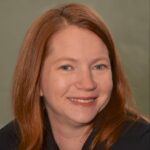 Smiling white woman with long red hair