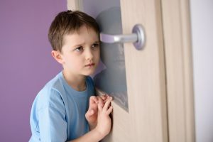 frightened child listening at door