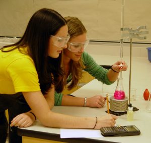 girls in science class with parents in mediation